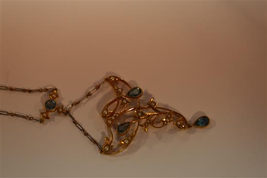 An Edwardian 15ct gold, aquamarine and seed pearl set foliate drop necklace with two colour gold chain,
